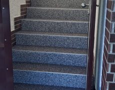 Treppe mit 11 Stufen hinter einer Tür im Eingangsbereich
